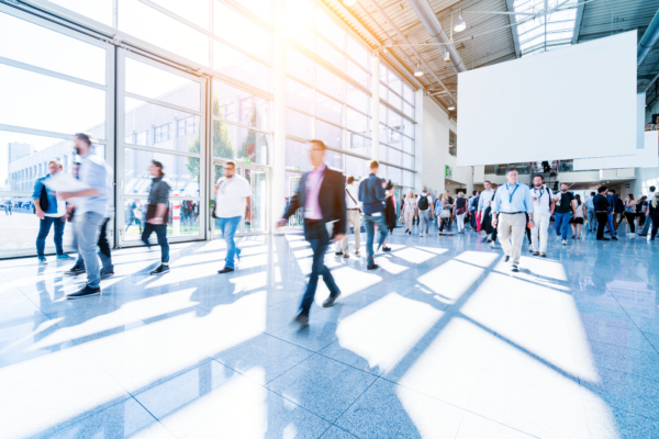 blurred people walking in a modern hall